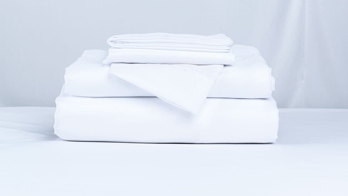 Folded bed sheets stacked on a neutral surface